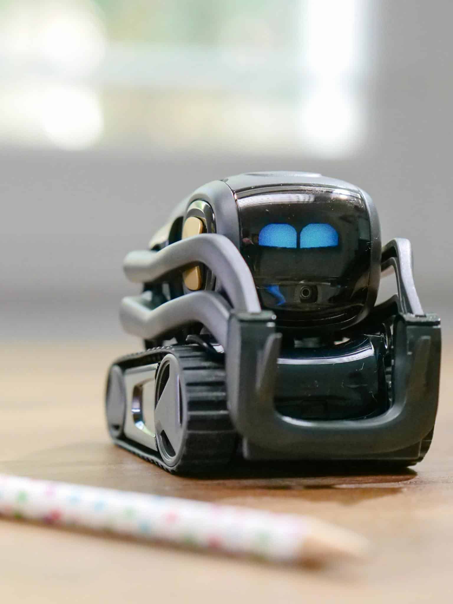 Explore the futuristic design of a miniature AI-powered robotic toy with modern technology elements.